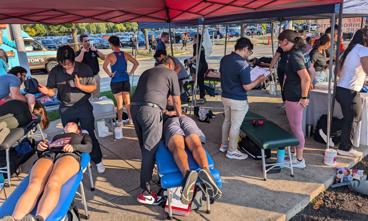 Northeast chiropractic students in action, providing free care to athletes at the ROC Flower City Half Marathon.